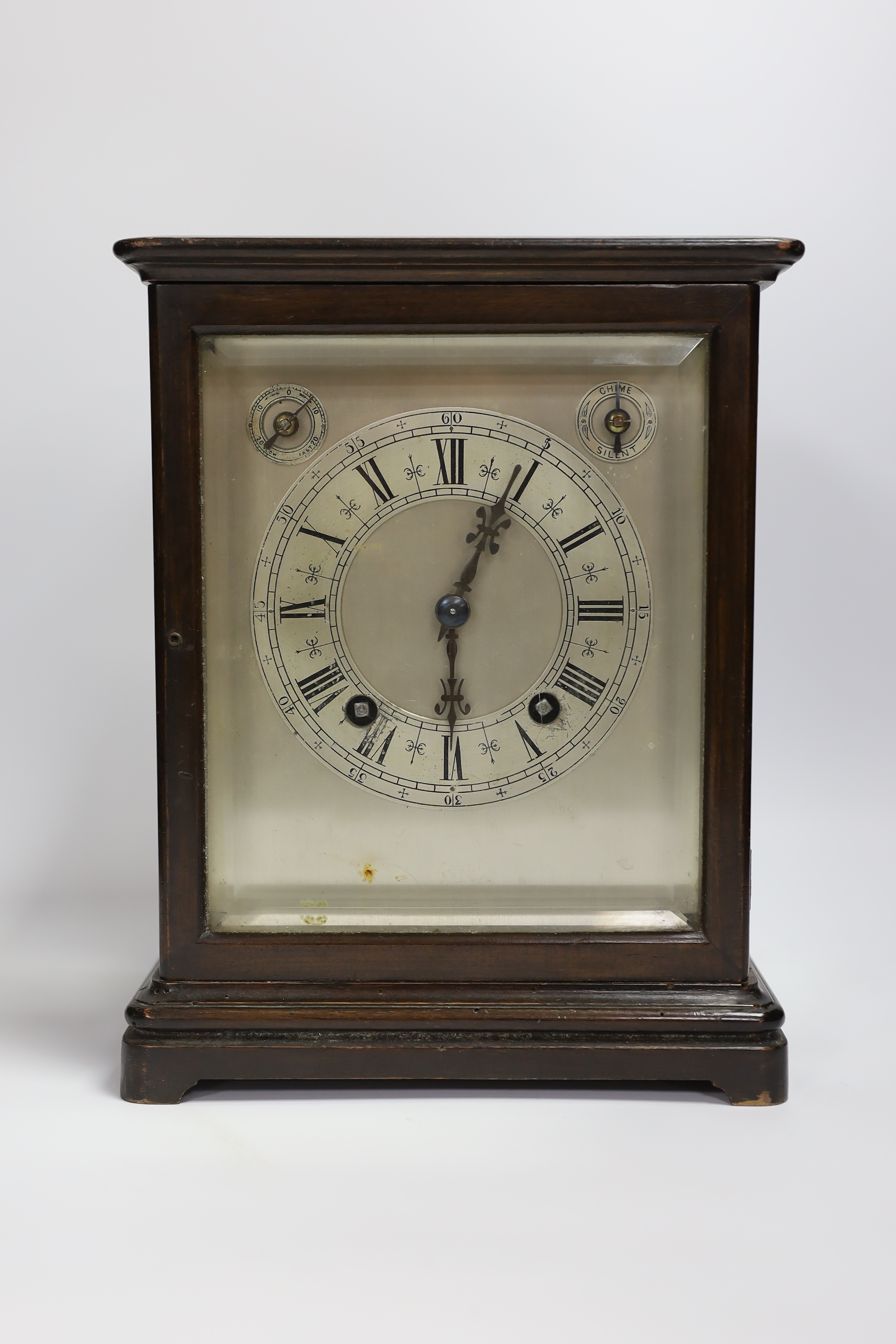 A mahogany striking mantel clock with silvered dial and German movement, 26cm high